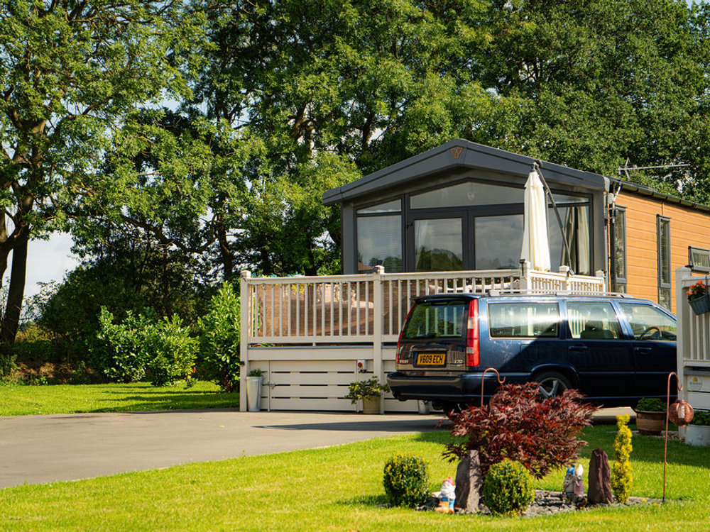 Lodge among mature trees at Wild Rose Country Park